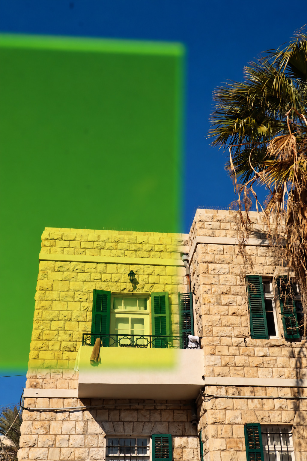 Keychain color layer held in front of a building
